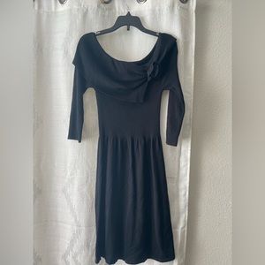 Black dress with a flower on the top.